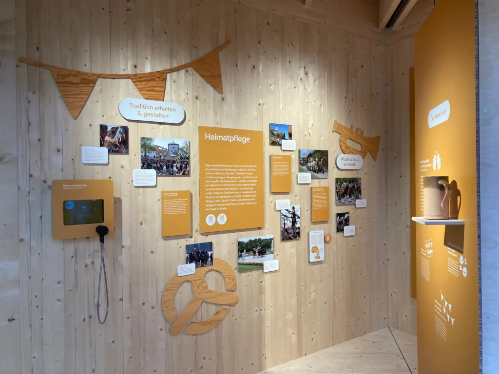 Fest installierte Medientechnik in einer Ausstellungswand mit Bildschirm und Hörstation